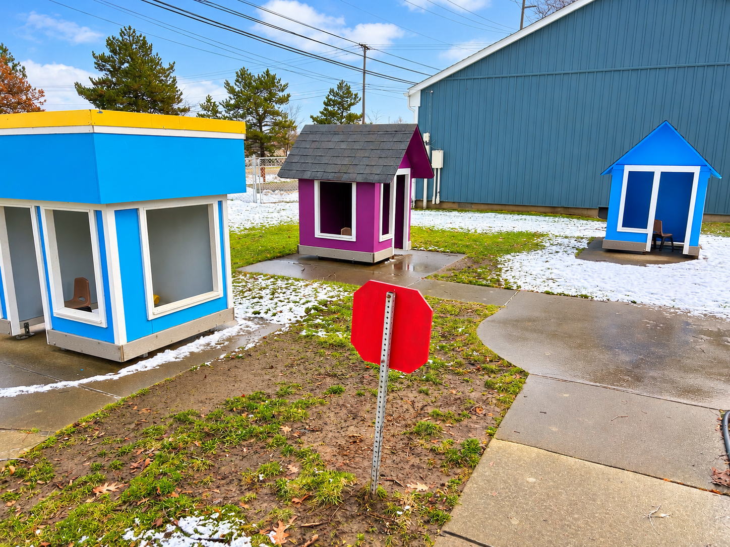 Colorful outdoor playhouses beside the center
