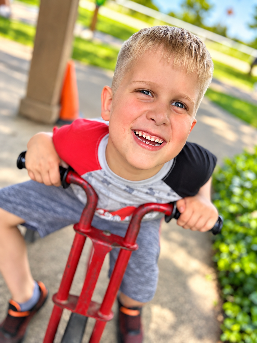 Child riding a play vehicle outdoors